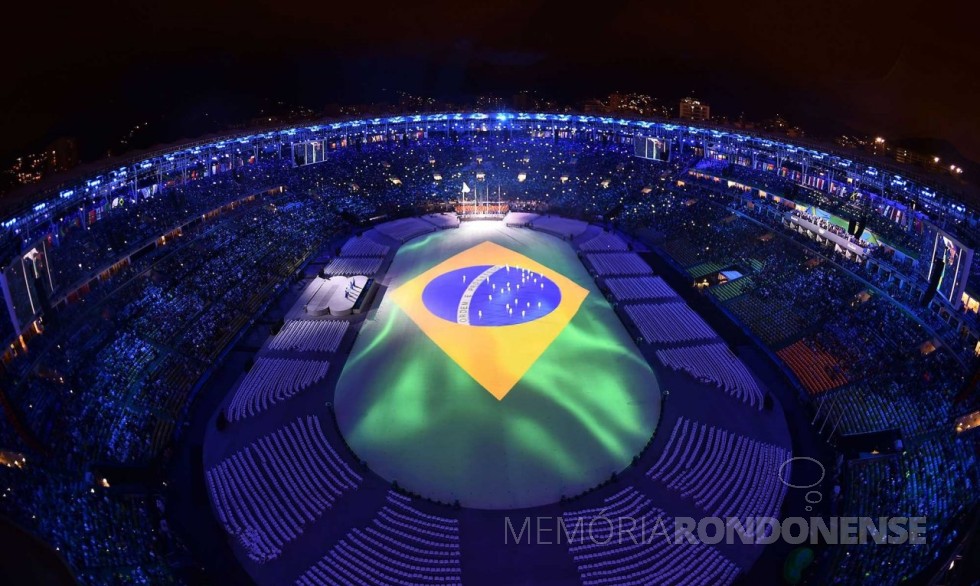 Representação da bandeira nacional no tablado que cobria o gramado do estádio do Maracaná, durante a execução do Hino Nacional. 
Imagem: Reprodução - FOTO 8 - 